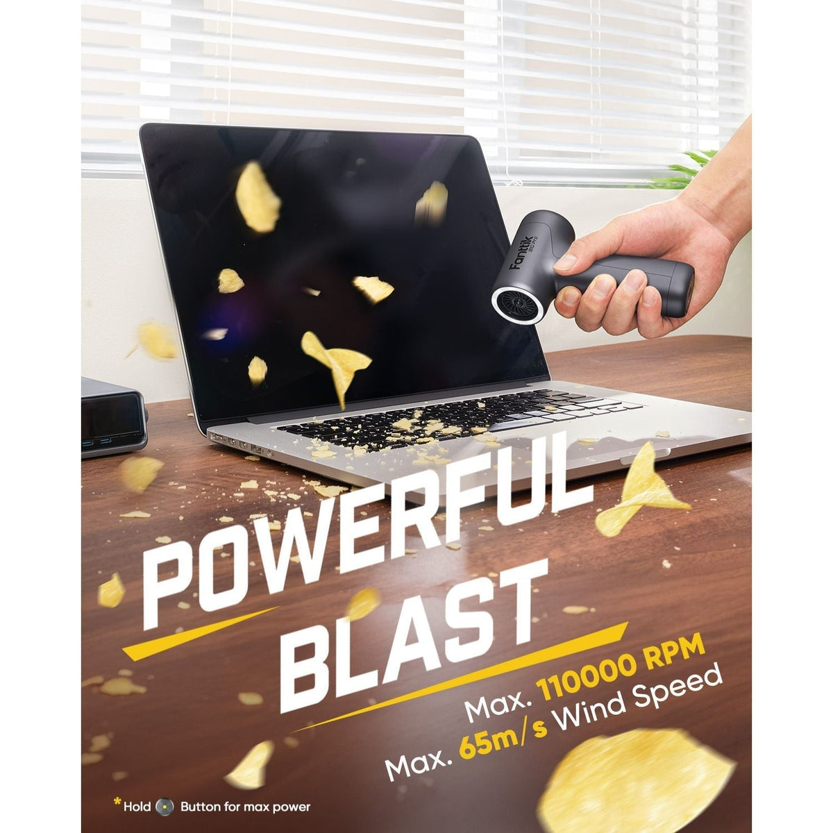 Fanttik B10 Pro electric air duster blowing debris off a laptop keyboard, max 110000 RPM