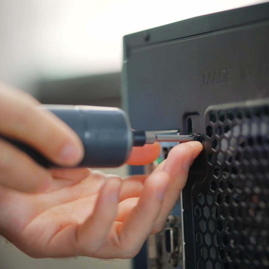 Hands using Fanttik S1 Pro cordless electric screwdriver to assemble computer case.