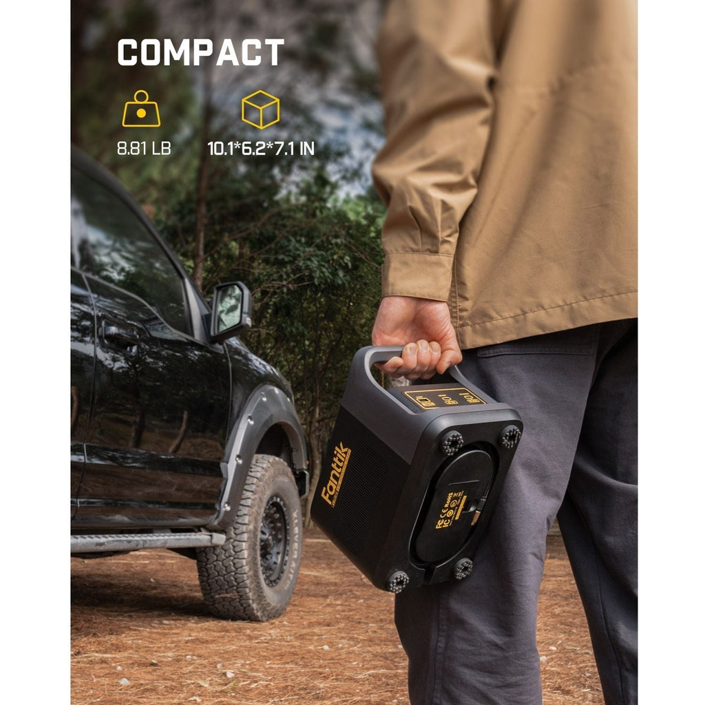 Fanttik X9 Ultra tire inflator for pickup trucks, 8.81 LB, compact. Held near an off-road truck.