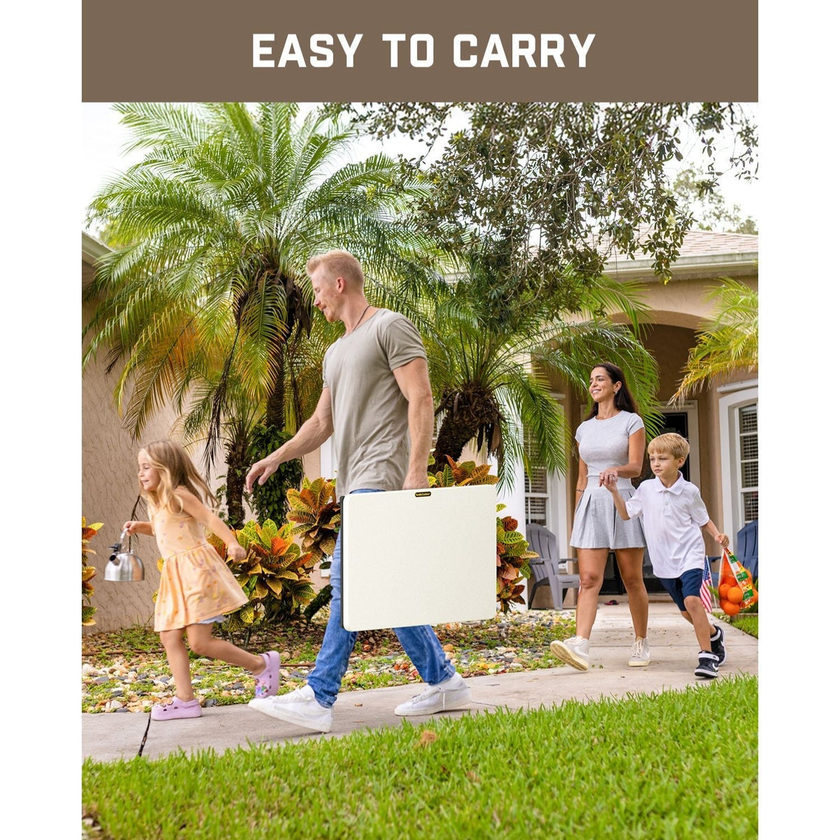 A family walks on a sidewalk carrying the FanttikOutdoor Zeta X1 Apex 28" folding table.